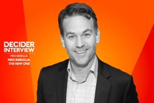 Mike Birbiglia in black and white on a bright orange background