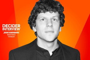 Jesse Eisenberg in black and white on a bright orange background