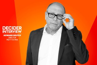 HOWARD DEUTCH in black and white on a bright orange background