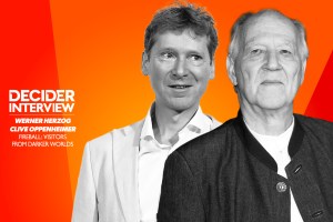 Werner Herzog and Clive Oppenheimer in black and white on a bright orange background