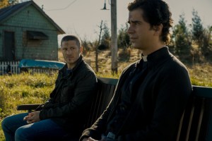 ZACH GILFORD as RILEY FLYNN and HAMISH LINKLATER as FATHER PAUL in Midnight Mass