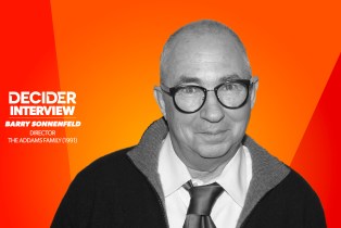 BARRY SONNENFELD in black and white in front of a bright orange background