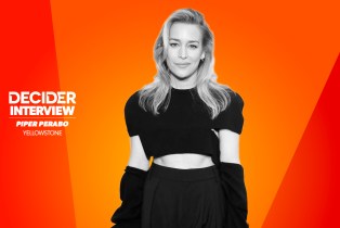 Piper Perabo in black and white in front of a bright orange background