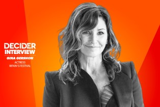 GINA GERSHON in black and white in front of a bright orange background