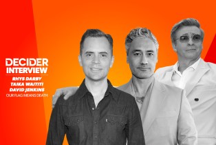 Rhys Darby, Taika Waititi, and David Jenkins in black and white in front of a bright orange background