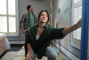 Katie Stevens as Melissa Norwood, and Victor Rasuk as David Phelps painting and on the phone with Sarah at the Norwood House as seen on A Christmas Open House