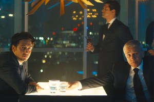 Nat Wolff (Craig), Christoph Waltz (Regus Patoff) sitting in a bar in 'The Consultant'