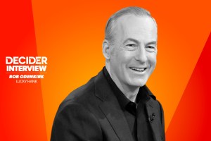 Bob Odenkirk in black and white on a bright orange background