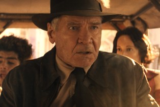 Indiana Jones looking pissed off in a rickshaw in 'Indiana jones and the Dial of Destiny'