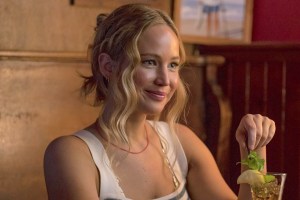 A still from No Hard Feelings: Jennifer Lawrence with a cocktail at a bar