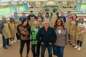 Noel, Prue, Paul, and Alison standing in front of the 2023 class of bakers in 'The Great British Baking Show' tent