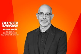 DAVID S GOYER in black and white on a bright orange background