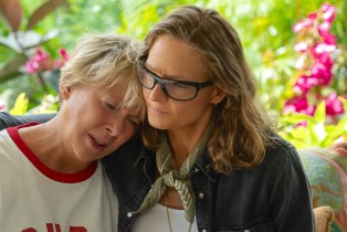 A woman with her arms around another woman in comfort. Annette Bening as Diana Nyad and Jodie Foster as Bonnie Stoll in NYAD.