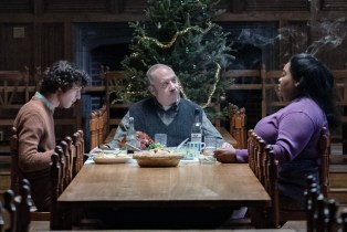 Dominic Sessa, Paul Giamatti, and Da'Vine Joy Randolph eating in front of a Christmas tree in 'The Holdovers'
