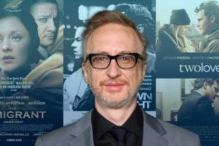 director James Gray in front of 3 movie posters