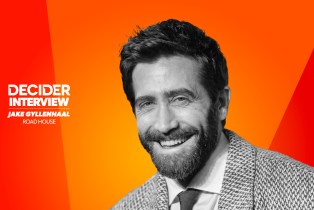 Jake Gyllenhaal in black and white on a bright orange background