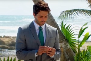 Joey Graziadei holding and looking down at an engagement ring on 'The Bachelor'