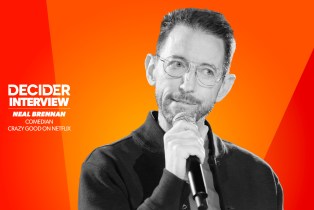 NEAL BRENNAN in black and white on a bright orange background