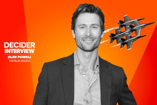 Glen Powell in black and white on a bright orange background