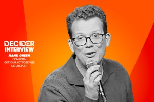 HANK GREEN in black and white on a bright orange background