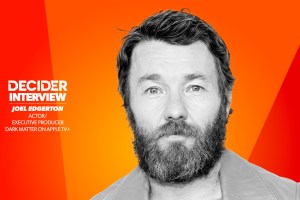 joel edgerton in black and white on a bright orange background