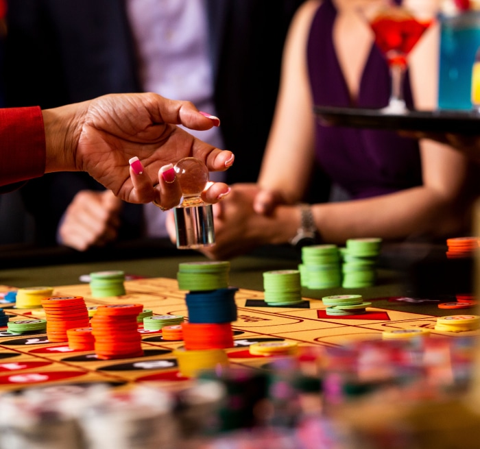 Dealer placing dolly on a roulette table after the ball has stopped spinning