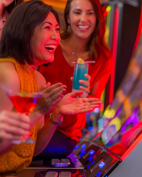 Woman winning and smiling at a slot machine