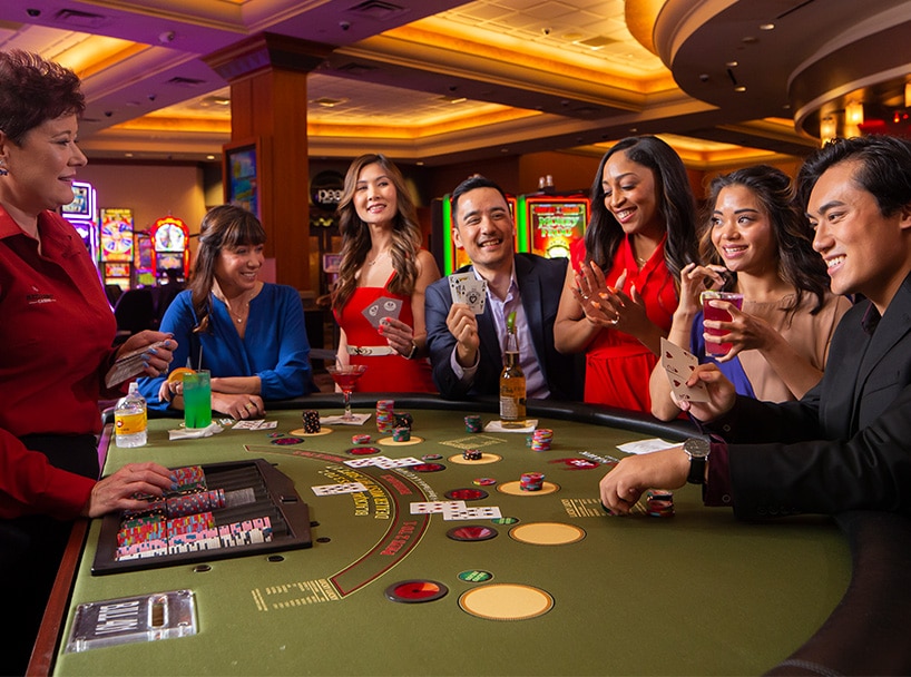 People playing blackjack with the player showing king and ace of spades