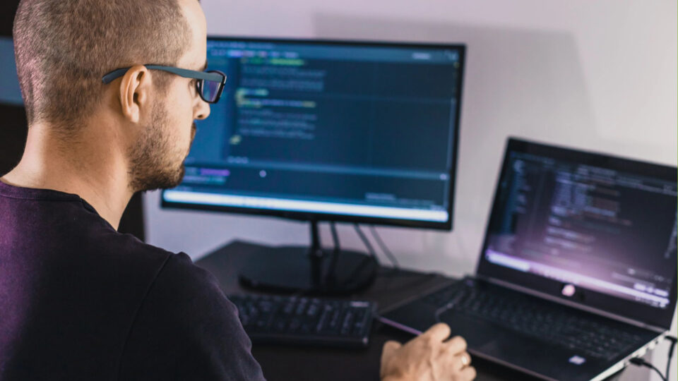 A man working at a laptop.