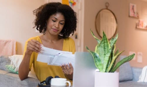 Woman reviewing mail.