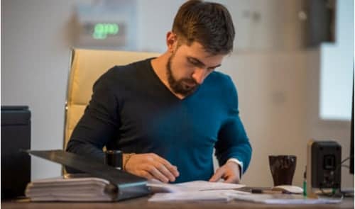 Man at desk reviewing documents.