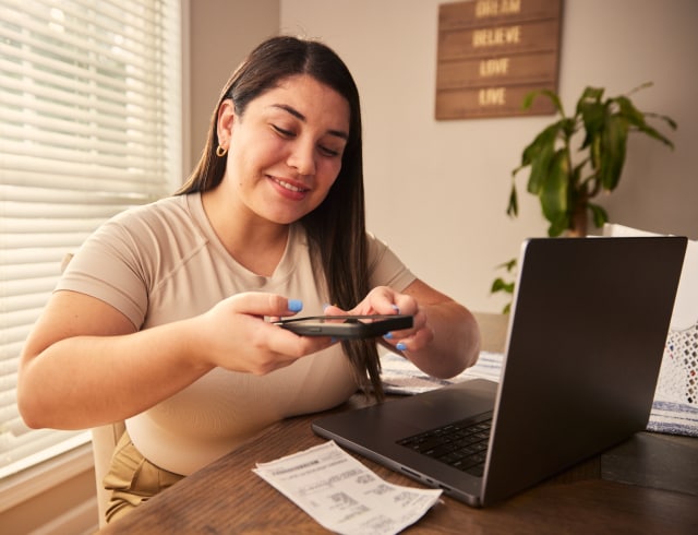 A person taking a picture of her tax forms.