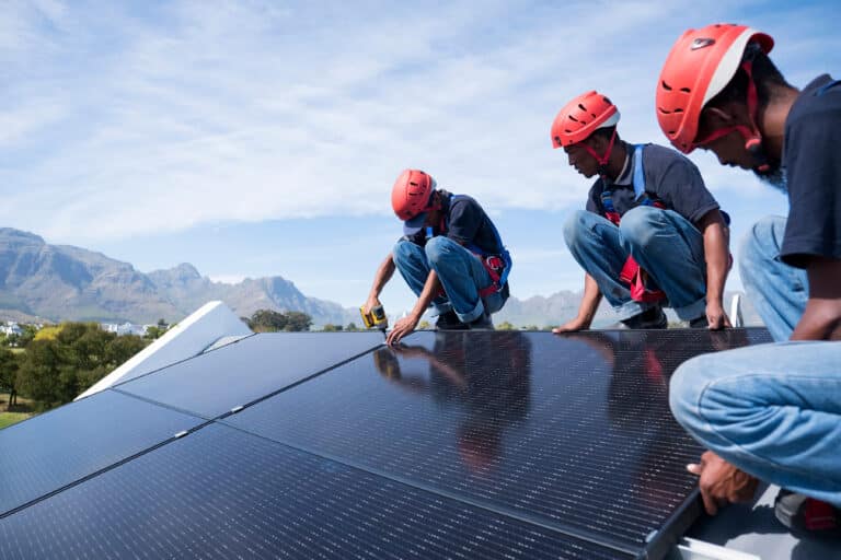 Men on a roof installing solar panels