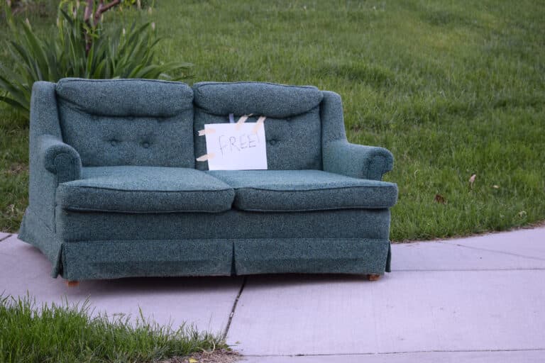 A vintage couch out on the curb awaiting charity pickup