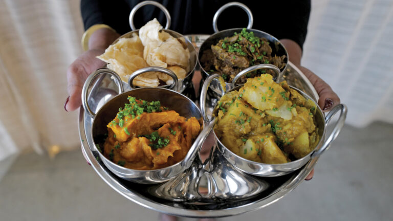 ‘Buss Up Shut’ (aka Paratha bread) with curry platter (beef, goat, etc.)