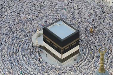 Muslim pilgrims circumambulate the Kaaba, the cubic building at the Grand Mosque, during the...
