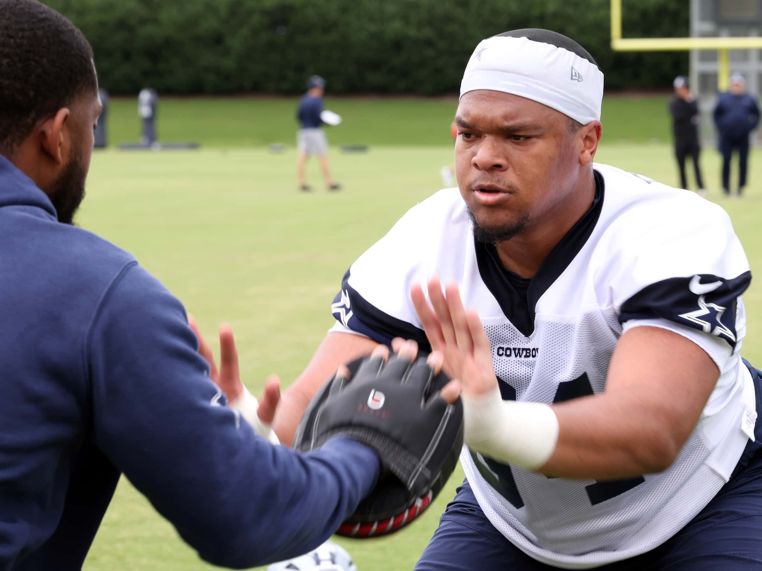 Dallas Cowboys defensive lineman Marshawn Kneeland (94) works on a hand-eye drill with a...