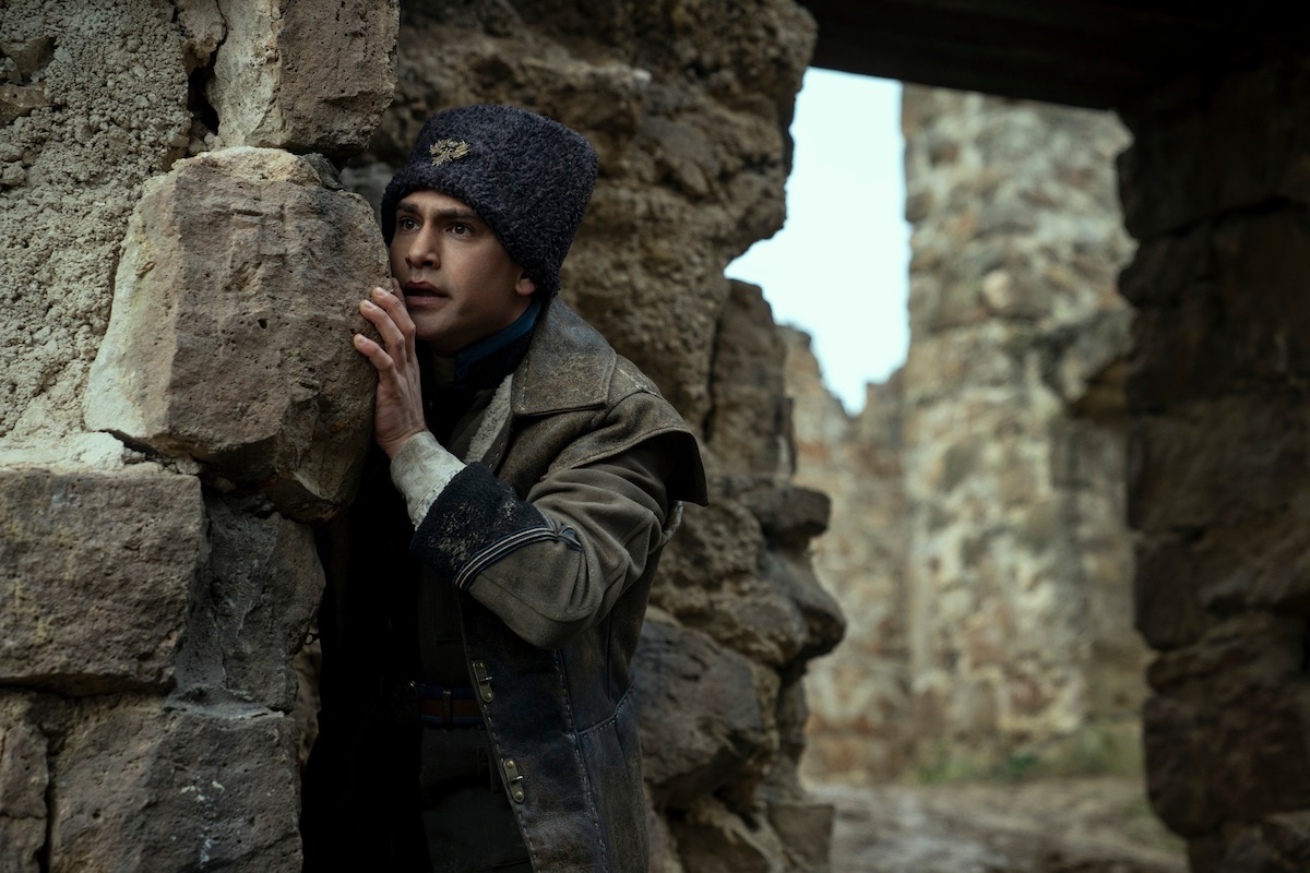 Luke Pasqualino hides behind a rock as David 