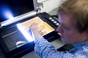 Book is being scanned on a flatbed scanner