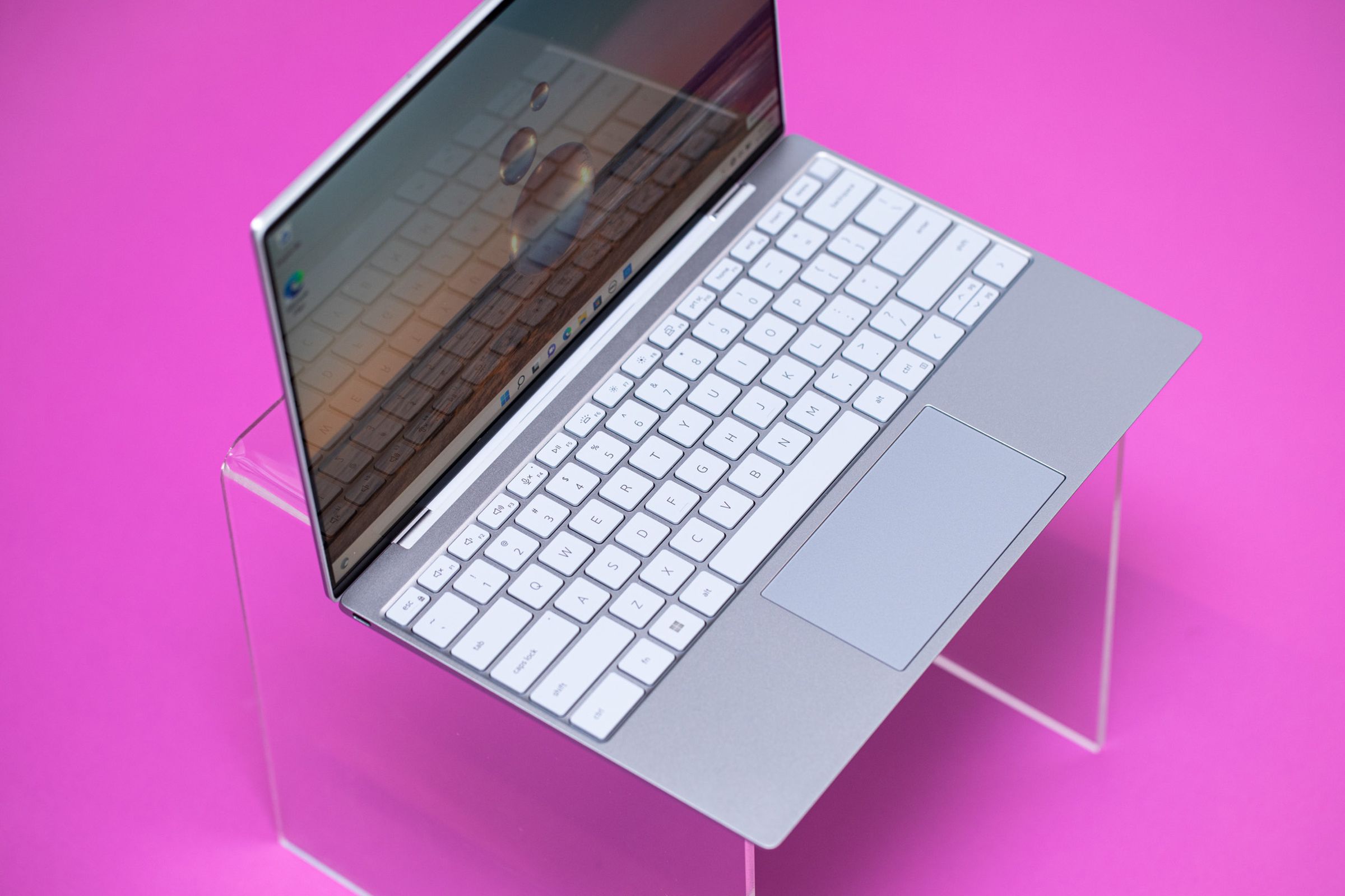 Best Laptop 2023: Dell XPS 13 on a pink surface seen from above.