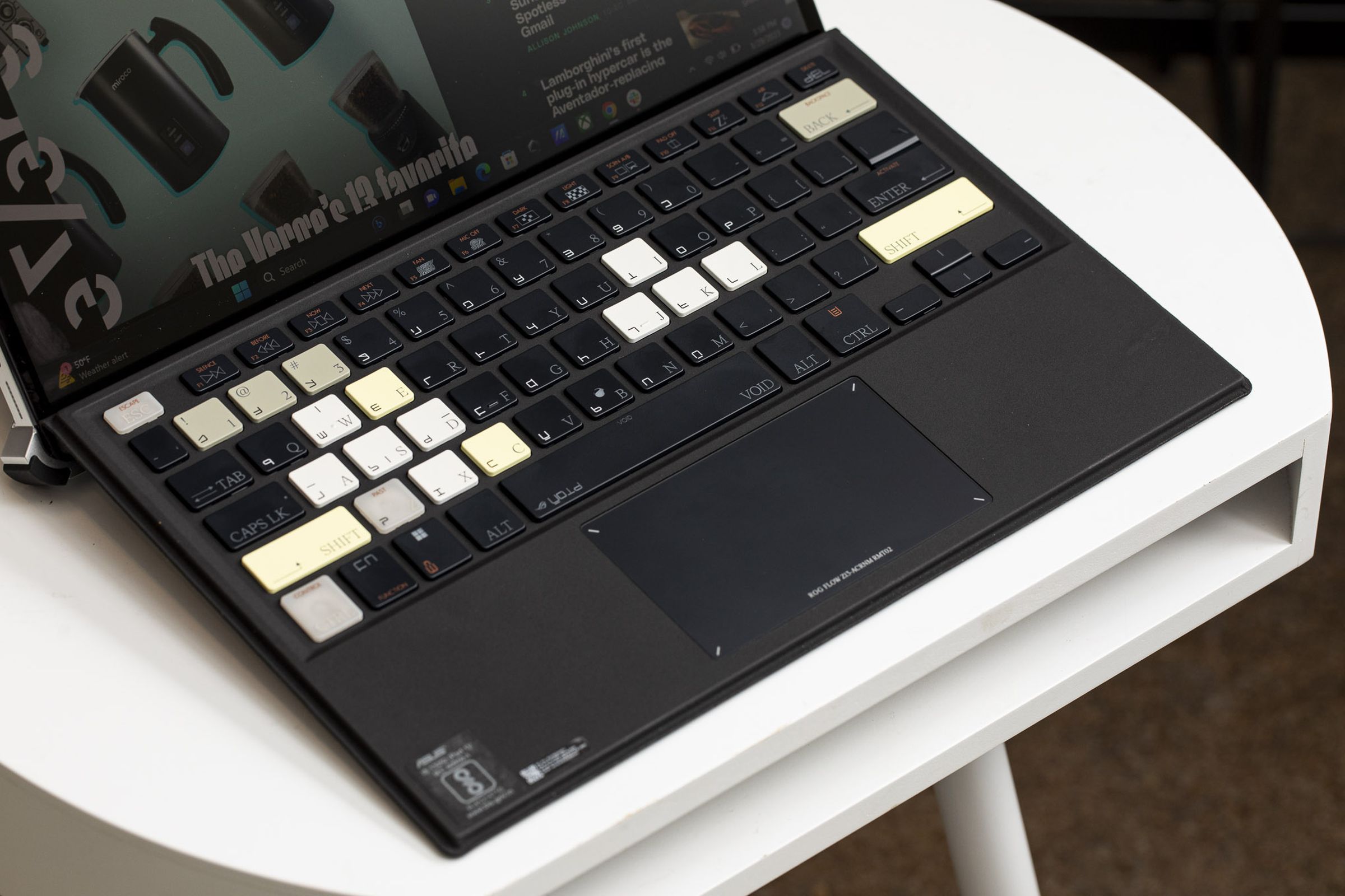 The Asus ROG Flow Z13 Acronym keyboard on a white table seen from above.