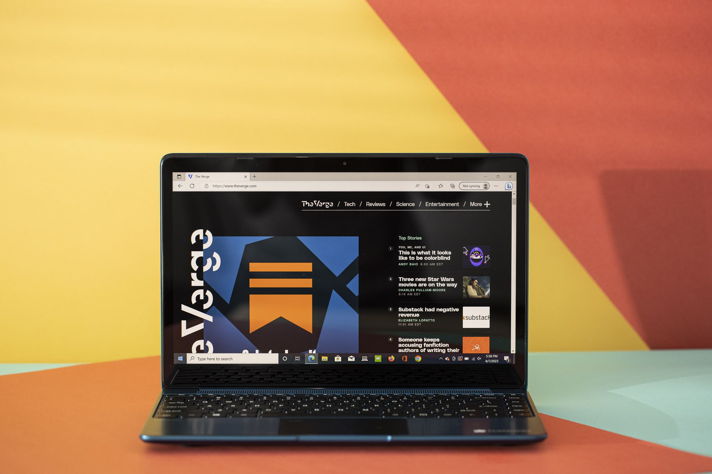 The Gateway 14 displaying The Verge homepage on an orange and yellow background.