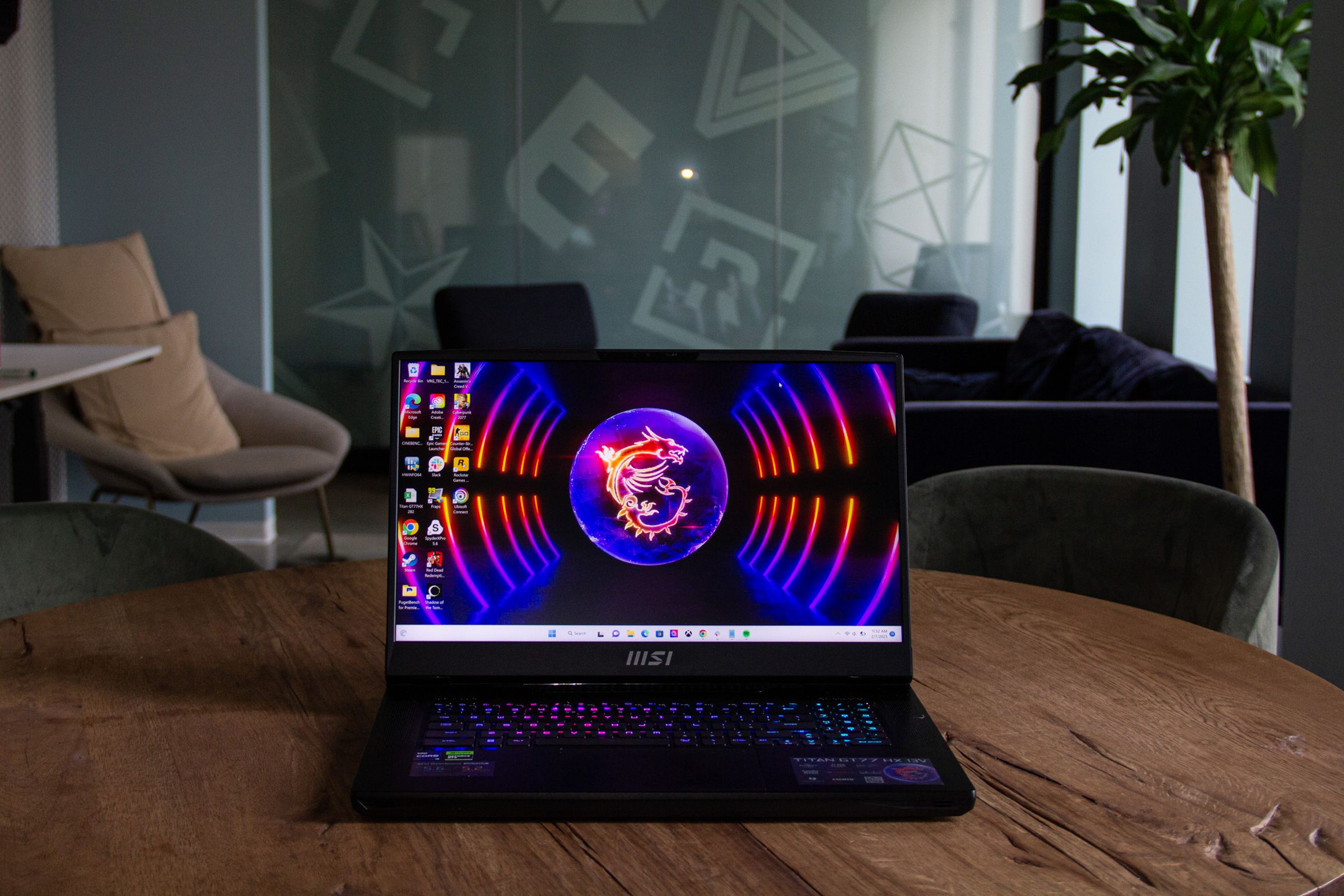 The MSI Titan GT77 HX displays a desktop with the MSI logo.