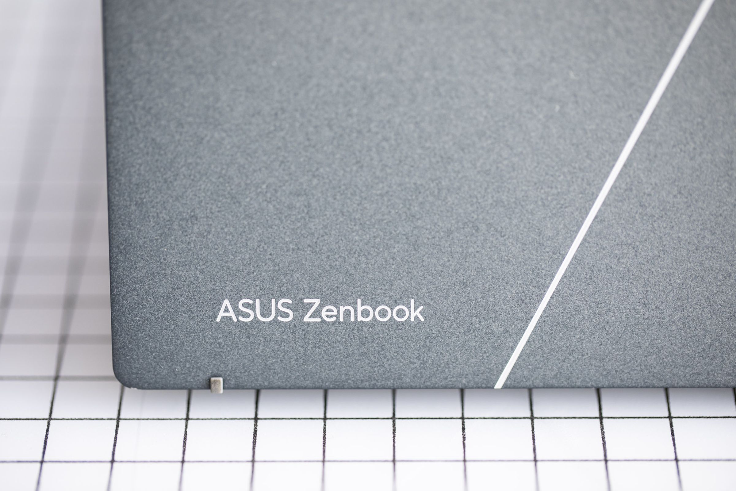 The Asus Zenbook logo on the lid of the Zenbook S 13 OLED.