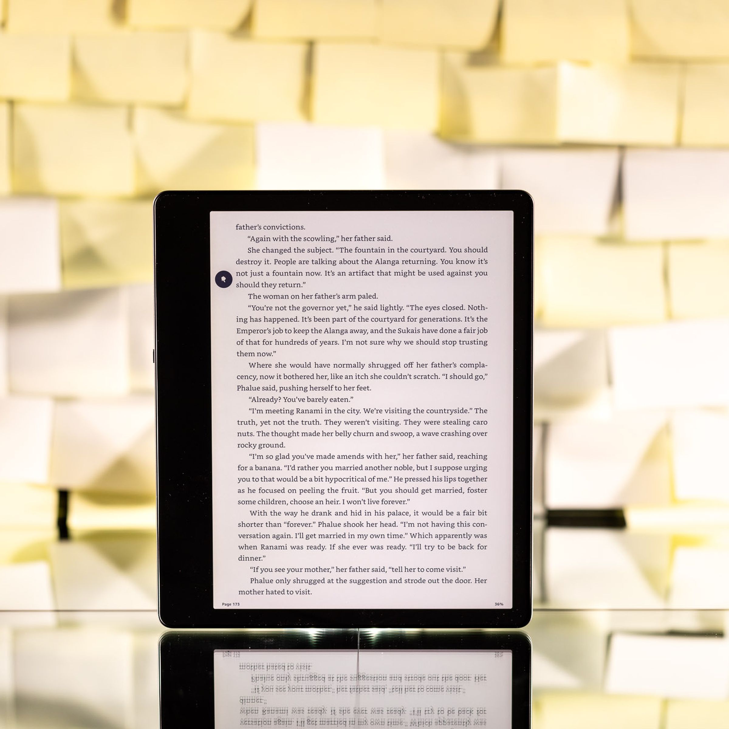 The Kindle Scribe turned on against a backdrop of Post-it notes.