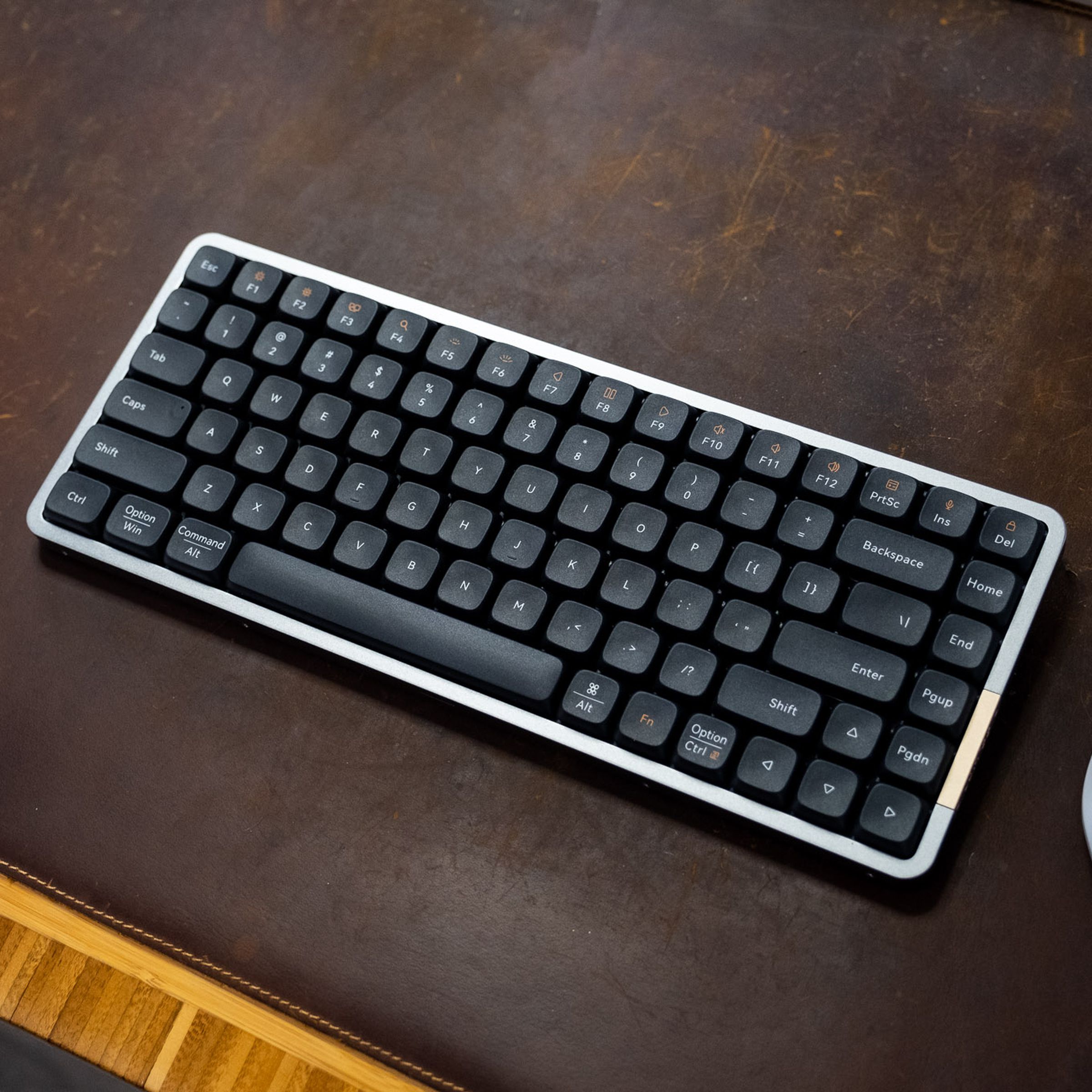 Lofree Flow keyboard on a brown deskmat, viewed from above.