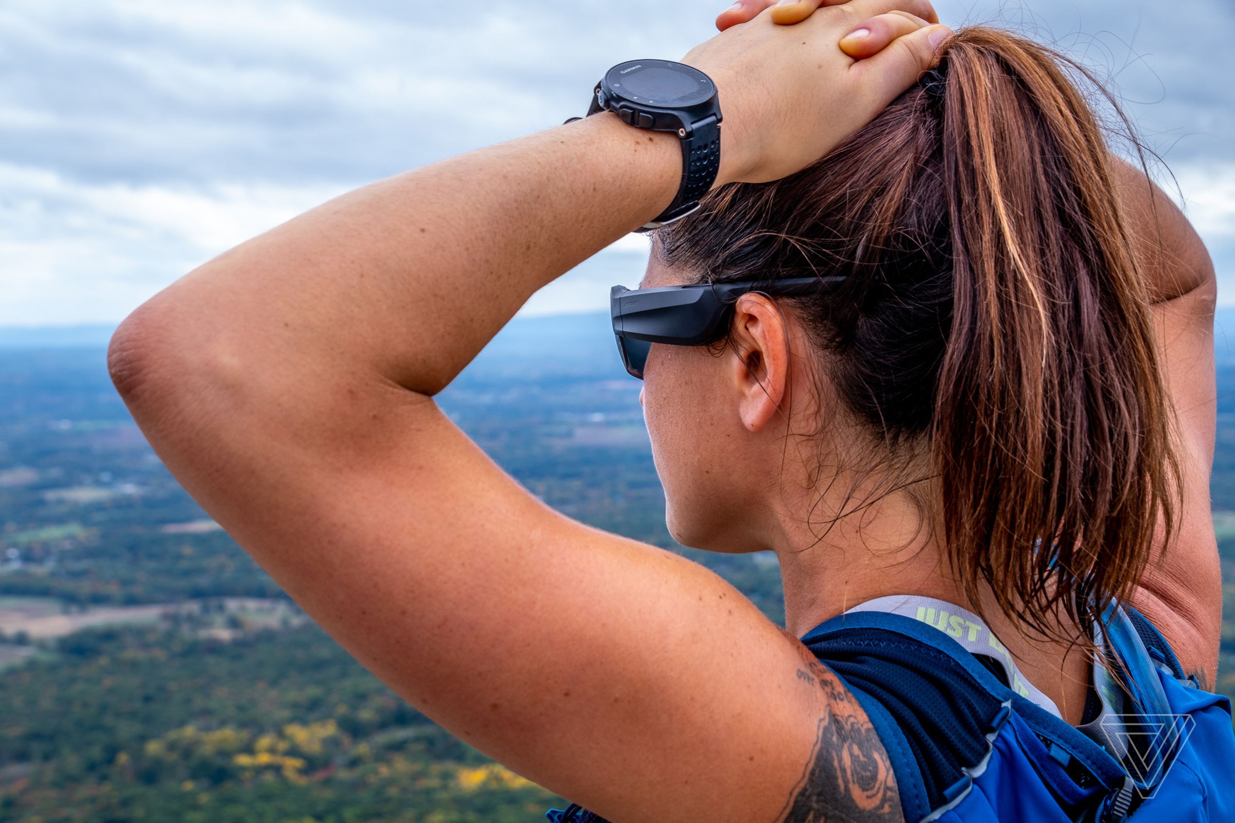 A photo of a woman wearing Bose’s Frames Tempo audio sunglasses.