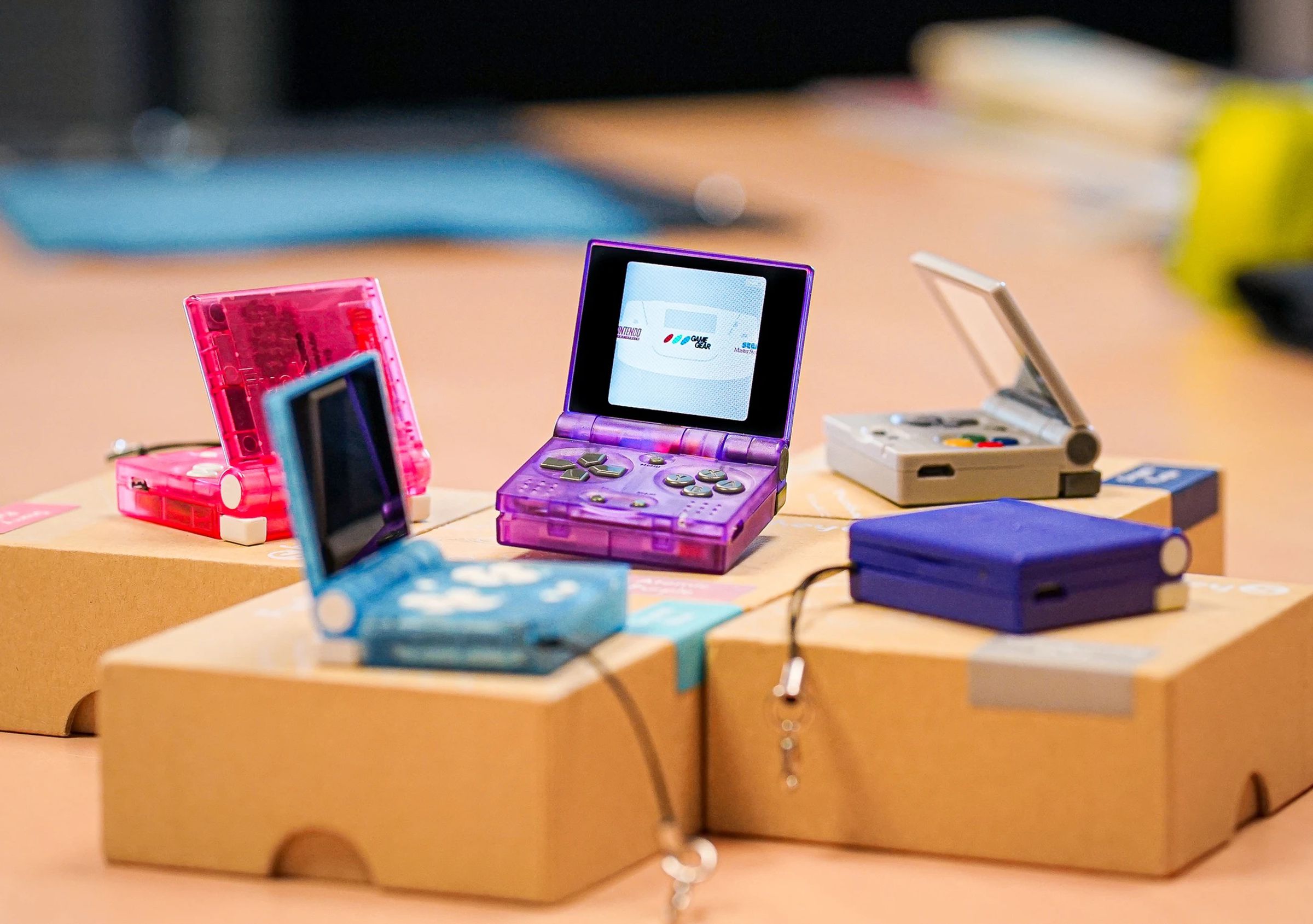 A group of very tiny folding retro game consoles.