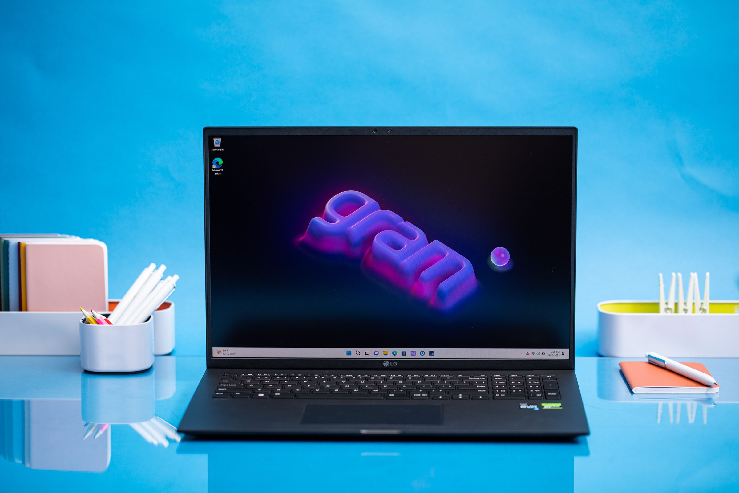 The LG Gram Pro 17 displaying a desktop background that has the Gram logo written in purple and pink.