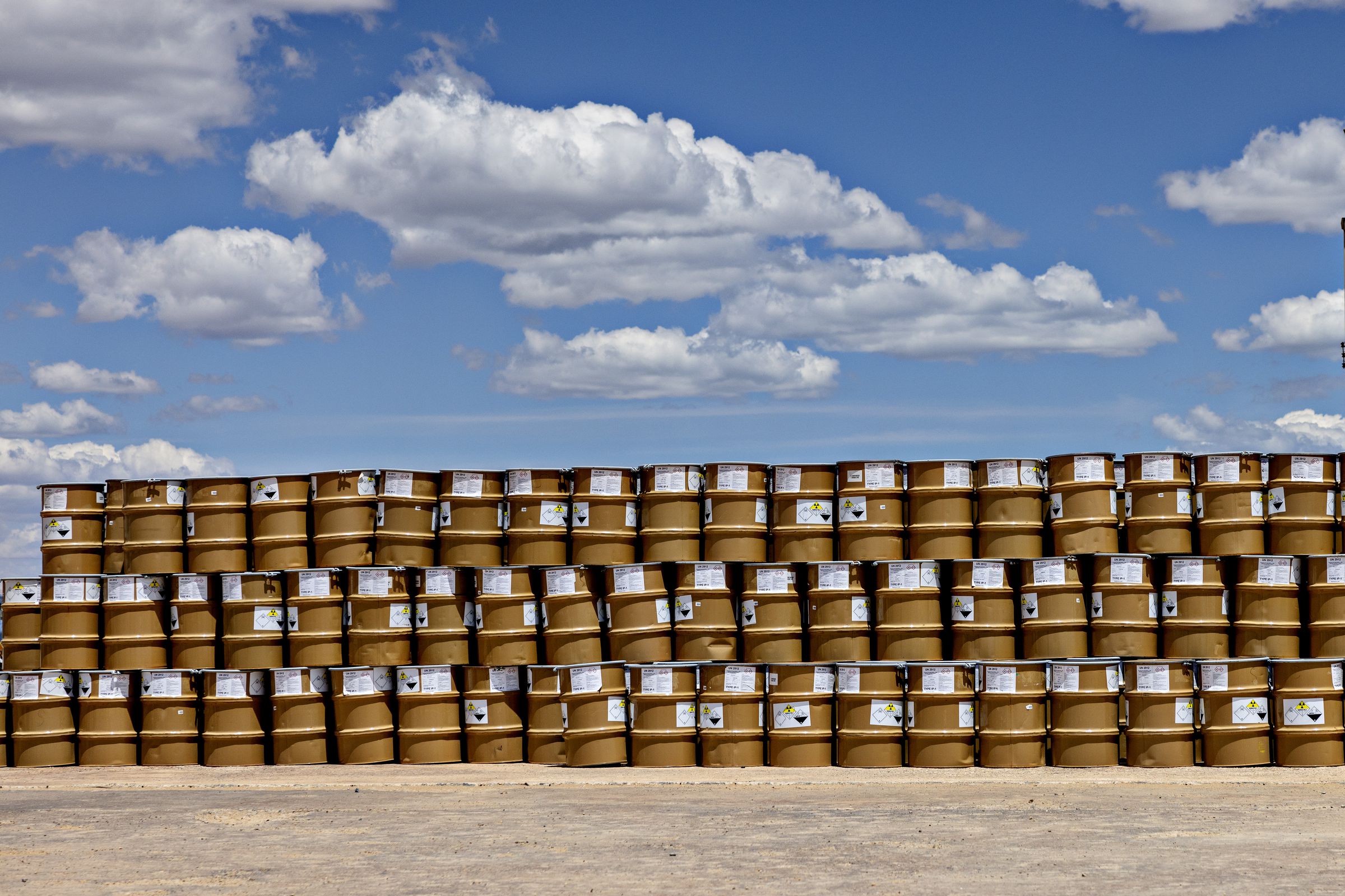 A long stack of barrels three rows high.